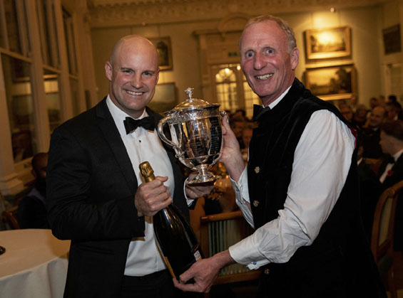 Helping hand: In Liam Livingstone's absence Andrew Strauss accepted the Walter Lawrence Trophy, a special medallion, a cheque for £2,500 and a magnum of Veuve Cliquot  on his behalf from host Matthew Fleming.